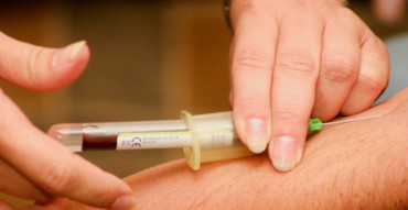 person injecting syringe