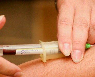 person injecting syringe