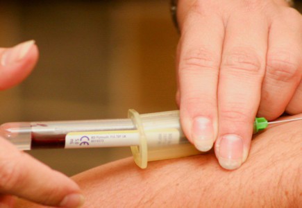 person injecting syringe