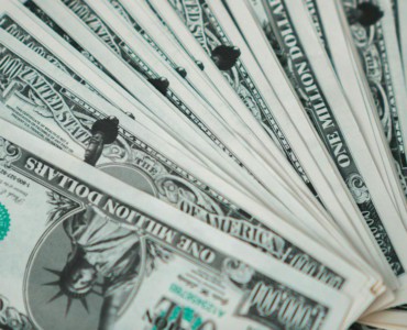 Closeup of novelty one million dollar bills laid out in a fan arrangement.
