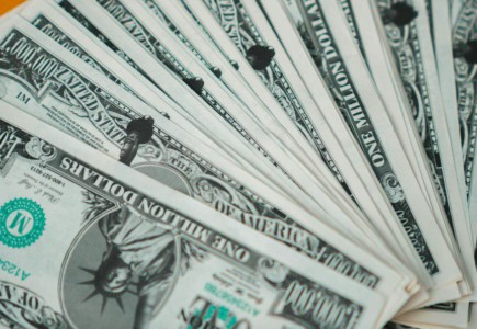 Closeup of novelty one million dollar bills laid out in a fan arrangement.