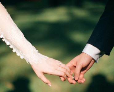 man and woman holding hands focus photo