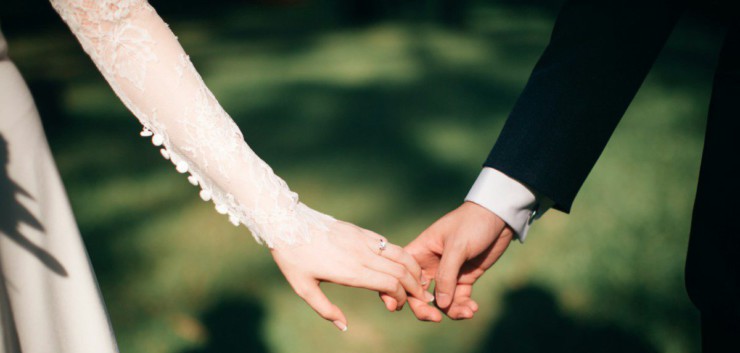 man and woman holding hands focus photo