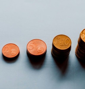 eight round gold coins on white surface