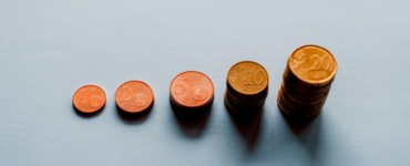 eight round gold coins on white surface