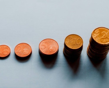 eight round gold coins on white surface