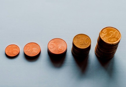 eight round gold coins on white surface