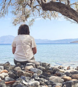 A person sits and enjoys the scenic seaside view.
