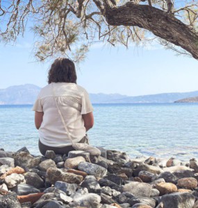 A person sits and enjoys the scenic seaside view.