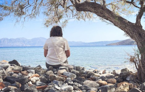 A person sits and enjoys the scenic seaside view.