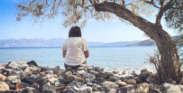 A person sits and enjoys the scenic seaside view.