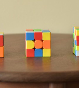 a wooden table topped with three different colored blocks