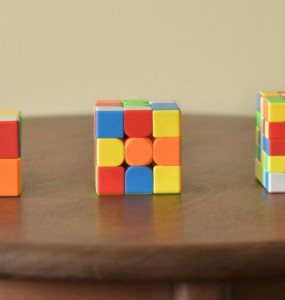 a wooden table topped with three different colored blocks