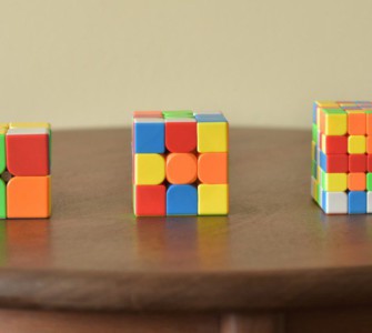 a wooden table topped with three different colored blocks