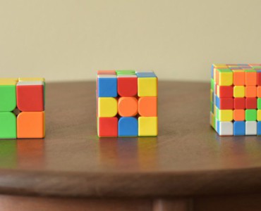 a wooden table topped with three different colored blocks