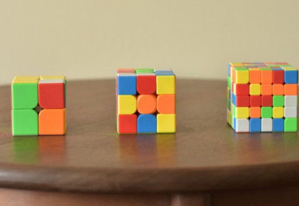a wooden table topped with three different colored blocks