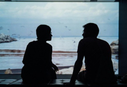 silhouette of man and woman sitting on ottoman