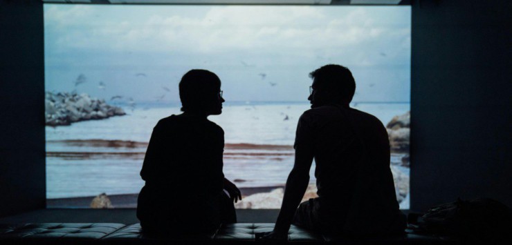 silhouette of man and woman sitting on ottoman