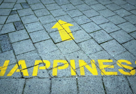 a brick sidewalk with a yellow arrow painted on it
