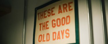A sign hanging on a wall that says these are the good old days