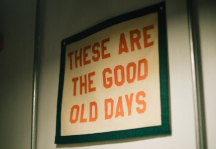 A sign hanging on a wall that says these are the good old days