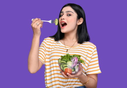 a person holding a bowl of fruit