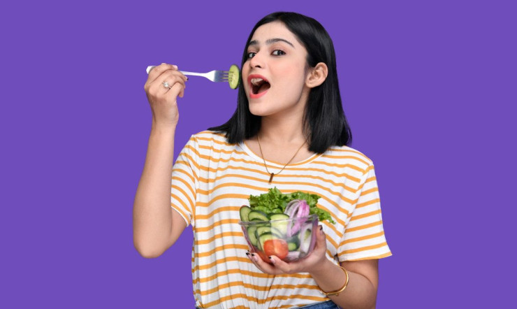 a person holding a bowl of fruit