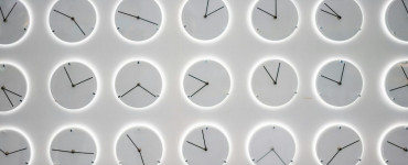 a white wall with many clocks on it