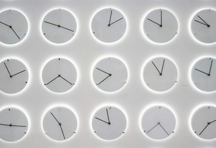 a white wall with many clocks on it