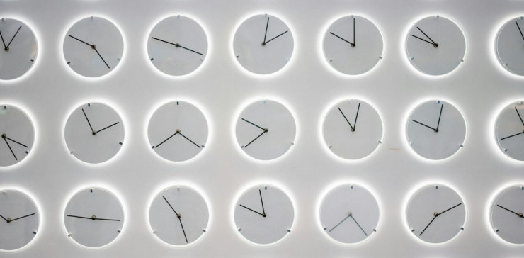 a white wall with many clocks on it