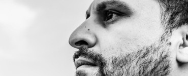 Close-up profile of a bearded man looking away