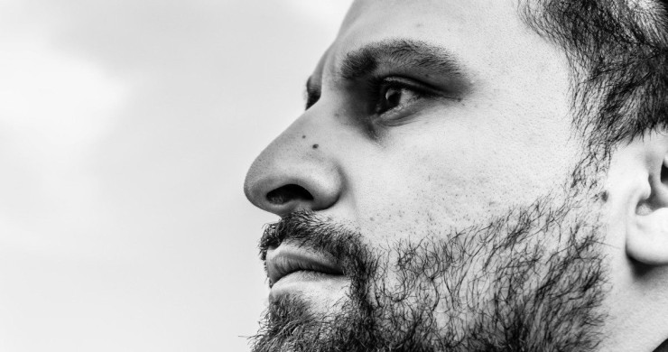 Close-up profile of a bearded man looking away