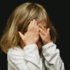 girl covering her face with both hands