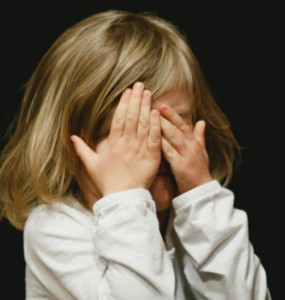 girl covering her face with both hands