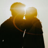 silhouette of man and woman about to kiss