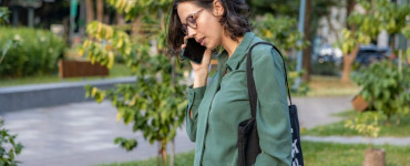 a woman talking on a cell phone in a park